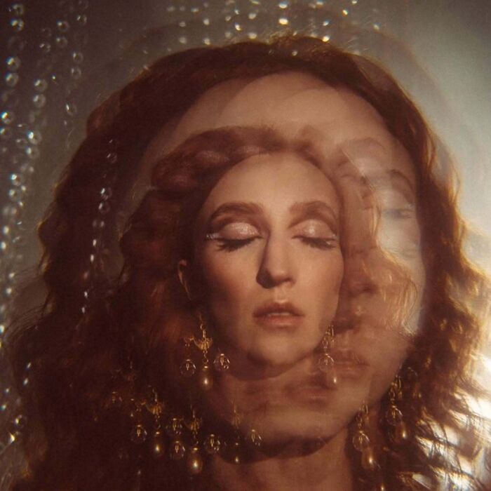 Portrait of a woman with closed eyes captured in an intimate, cinematic-looking shot using vintage cameras.