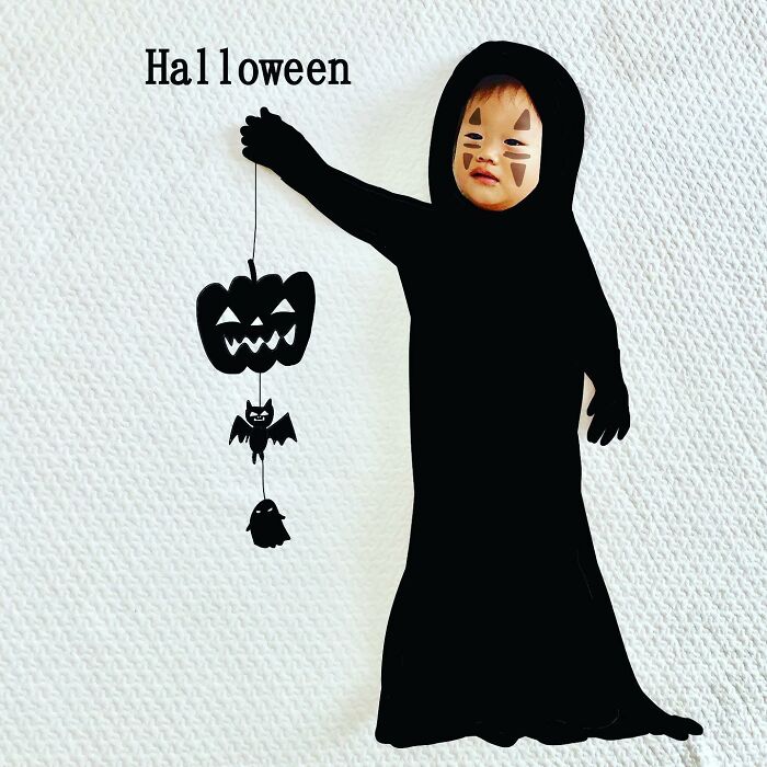Child dressed as a ghost with Halloween face paint, featuring artwork by Japanese father drawing on his kids’ photos.