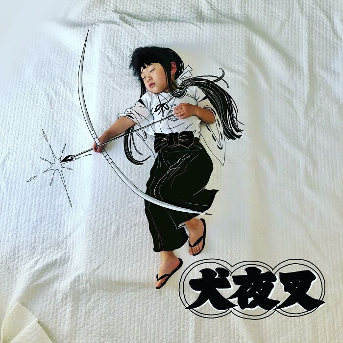 Sleeping child with drawn bow and arrow, inspired by Japanese father of two drawing on his kids’ photos.
