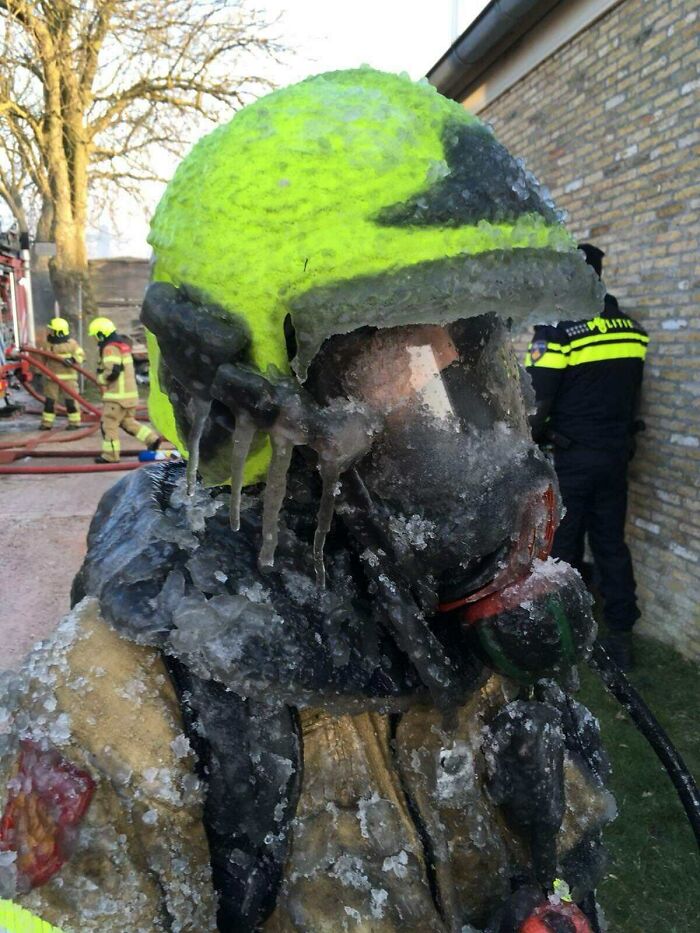 Firefighter covered in ice after a freezing rescue, showcasing one of the fascinating pictures for curious minds about the world.