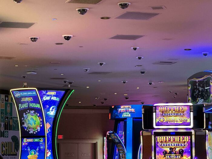 Arcade machines with colorful lights in a gaming room, perfect for curious minds wanting to learn more about the world.