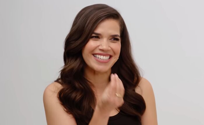 Actress smiling and gesturing with hand in an indoor setting, related to celebrities and hygiene habits discussion.