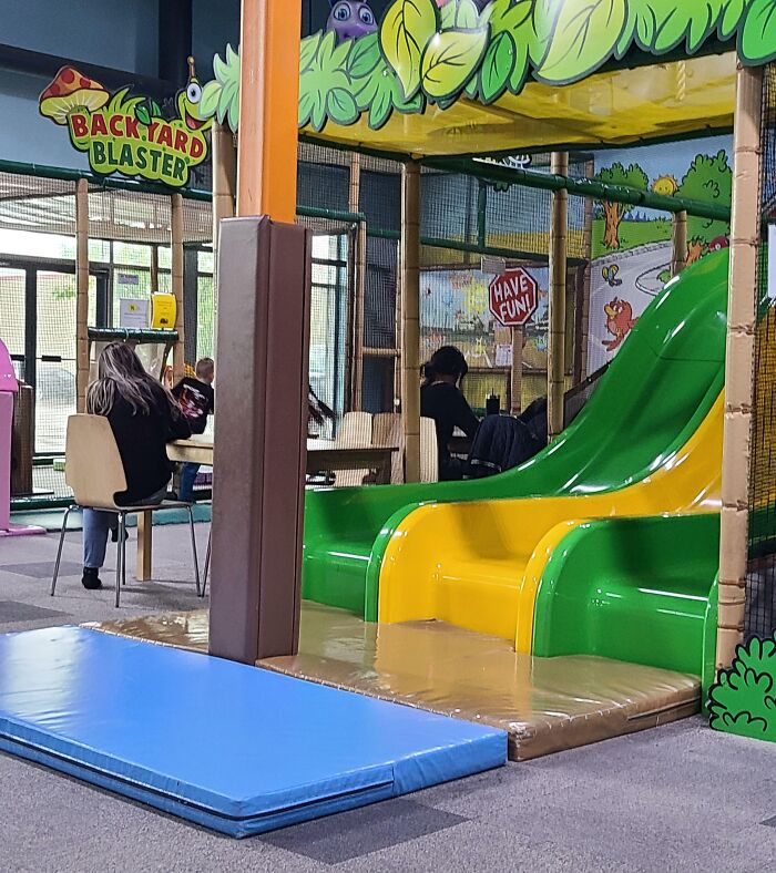 Indoor kids play area with slides and safety mats illustrating dangerous designs that could be death traps.