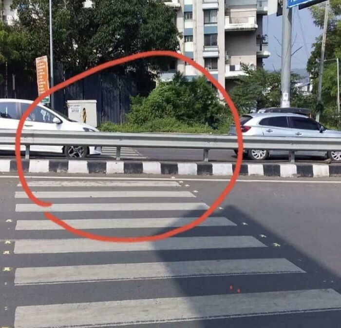 Pedestrian crossing blocked by a metal barrier, illustrating one of many dangerous designs classified as death traps.