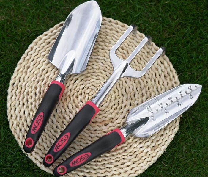 Gardening tools with ergonomic handles on a woven mat, perfect for managing your garden's tiny tantrums effectively.