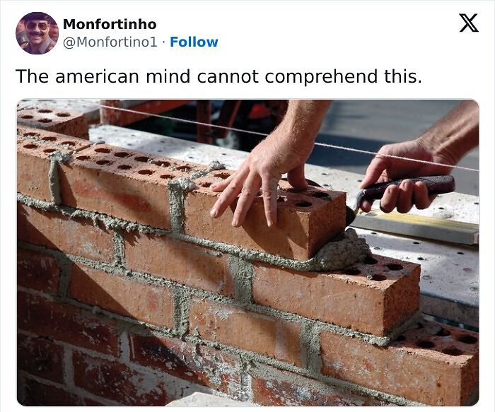 Hands laying bricks with uneven mortar on a brick wall, illustrating a confusing construction method baffling American minds.