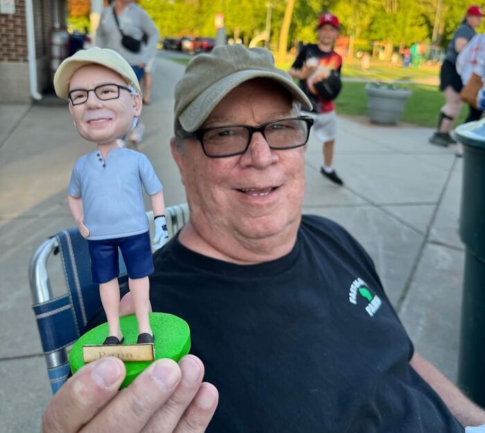 Man holding personalized golf bobblehead gift, showcasing unique Father's Day finds to spoil your old man.