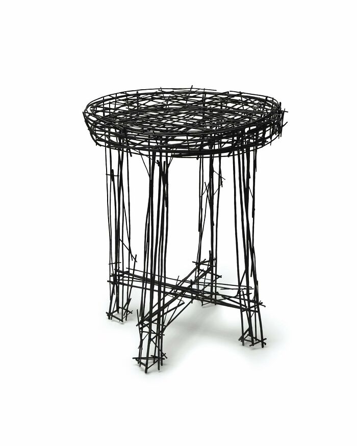 Black metal furniture piece resembling abstract doodles, showcasing unique design inspired by notebook sketches.