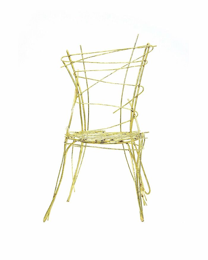 Wireframe furniture piece resembling a sketchy doodle chair with thin, tangled metal rods and artistic notebook-style design.