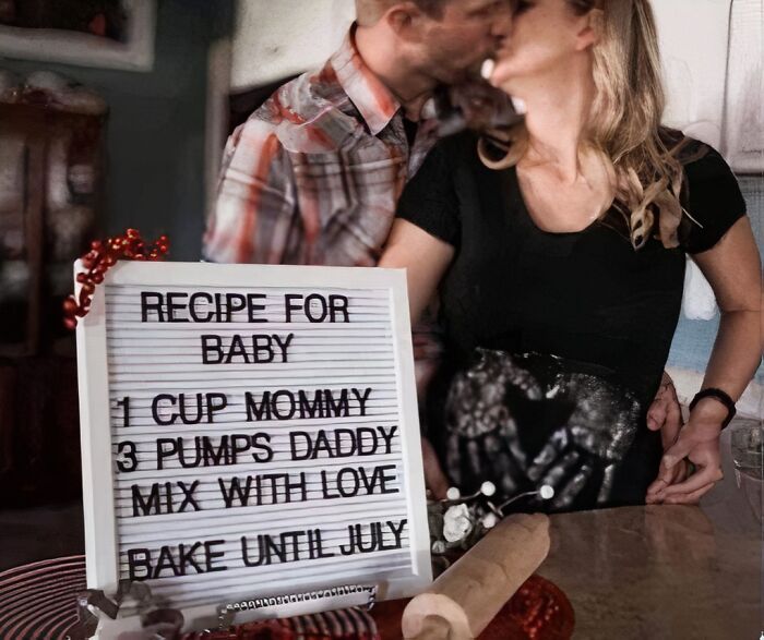 Couple kissing behind a sign with a controversial baby recipe, showcasing outrageous hot takes shared publicly.
