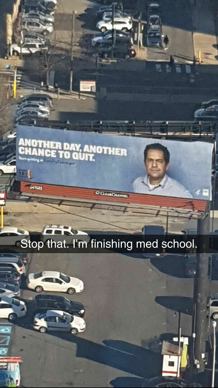 Billboard with motivational quitting message seen from above in a parking lot, illustrating medical school memes for future doctors.