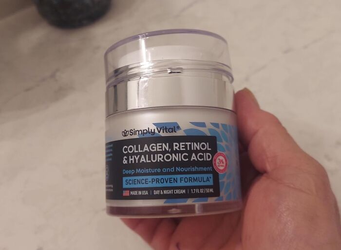 Simply Vital collagen retinol and hyaluronic acid cream held in hand for summer glow up skincare routine.