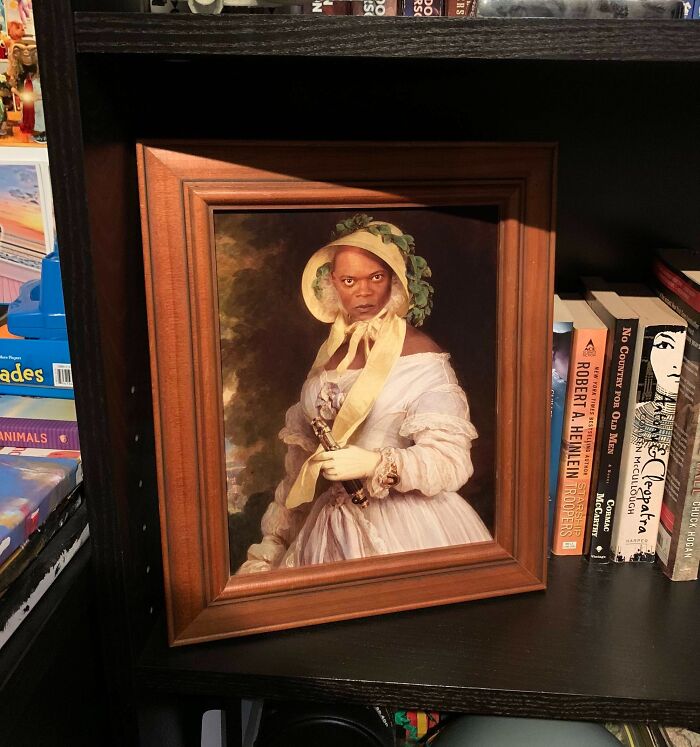 Framed humorous Photoshop art blending a modern face with a classical portrait style on a bookshelf with books.