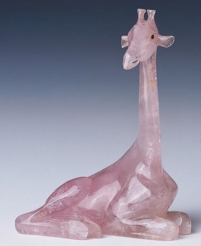 Rose quartz sculpture of a giraffe, an archeological and art wonder showcasing ancient craftsmanship and design.