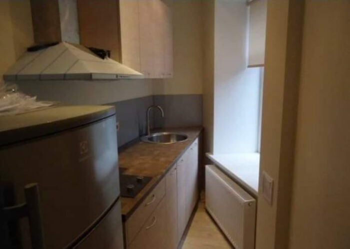 Narrow kitchen with poor interior design decisions, showing cramped counter space and awkward layout choices.