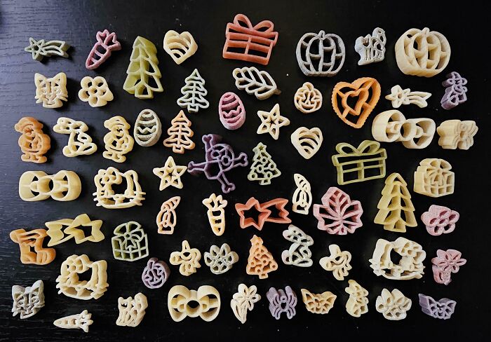 Collection of colorful shaped pasta pieces displayed on a dark surface showcasing unusual collections in homes