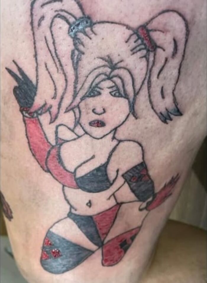 Tattoo of a woman with pigtails and mismatched red and black outfit showing a permanent ink mistake on skin.