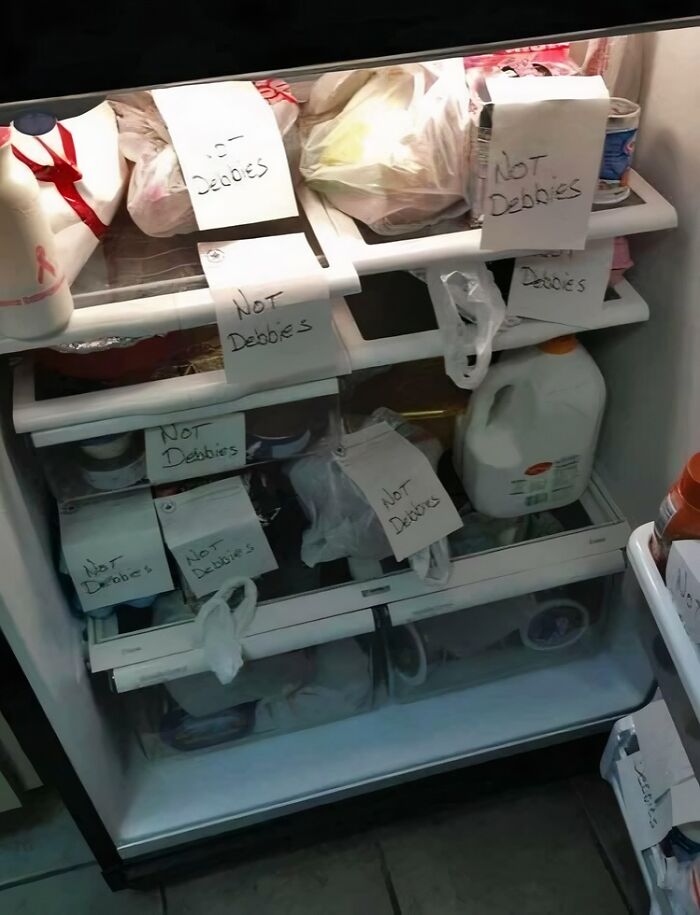 Refrigerator filled with food and notes reading not Debbies in a hilarious example of main characters in the worst way possible.