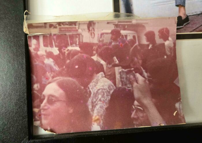 People share found photos of a crowded vintage street scene with people wearing glasses and casual clothing.