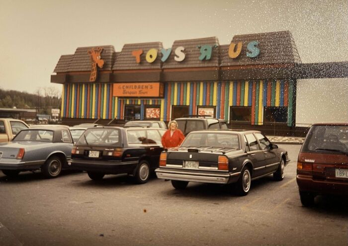 Vintage photo of people outside a Toys R Us store in a parking lot, showcasing found photos from the past.