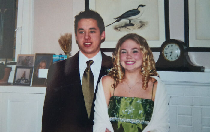Young couple dressed up, smiling and posing indoors, people share found photos capturing memorable moments.