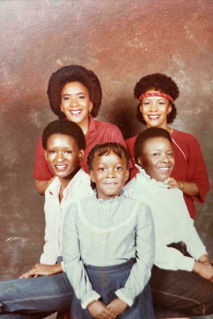 Five people smiling in a vintage portrait, showcasing diversity as people share found photos from the past.