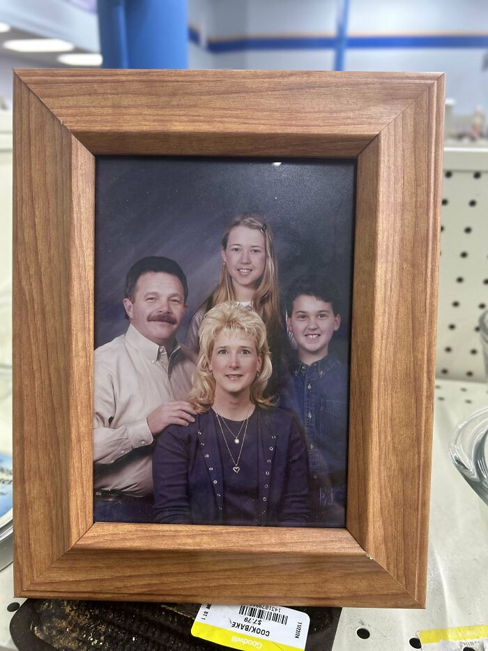 Framed family portrait photo of four people on display, representing people share found photos concept.