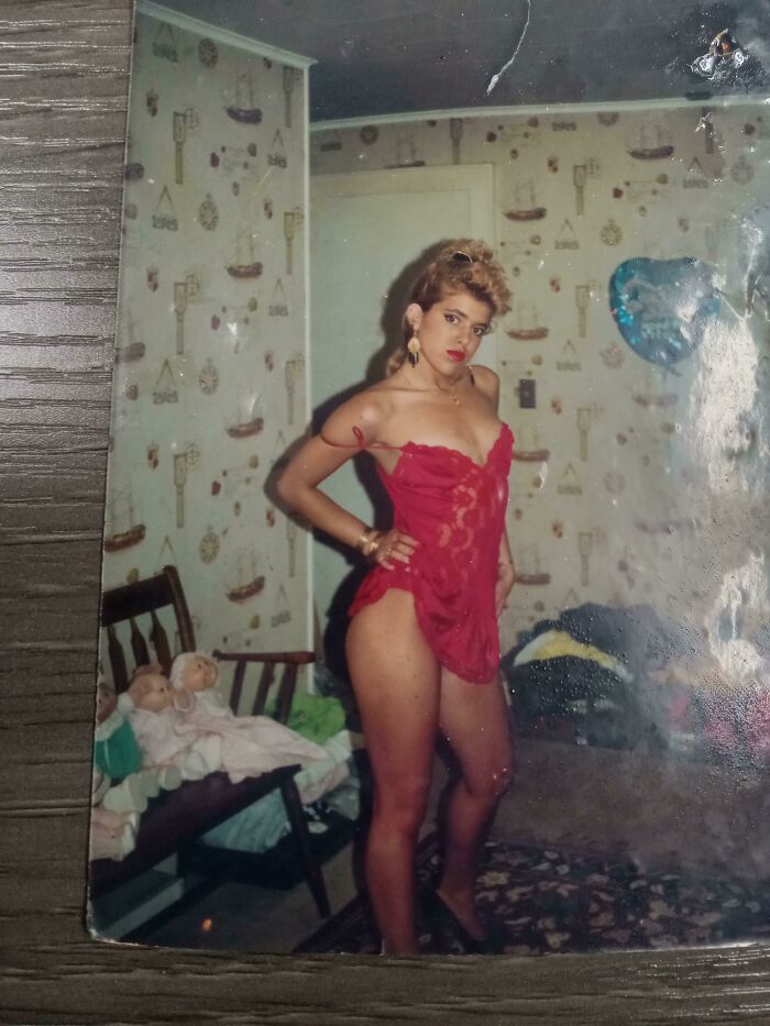Woman posing in red lingerie indoors, capturing a vintage style moment in people-share-found-photos collection.