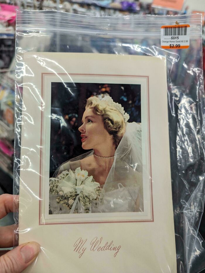 Vintage wedding photo found in a sealed plastic bag, held by a person in a store, illustrating people share found photos.