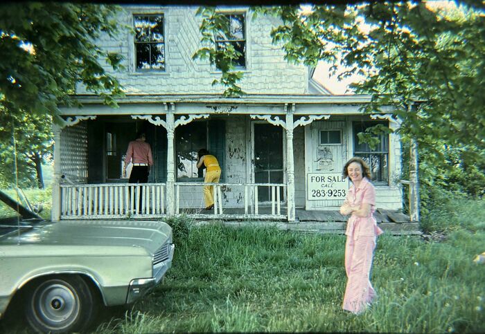 People share found photos of a vintage car and three individuals outside an old house with a for sale sign.