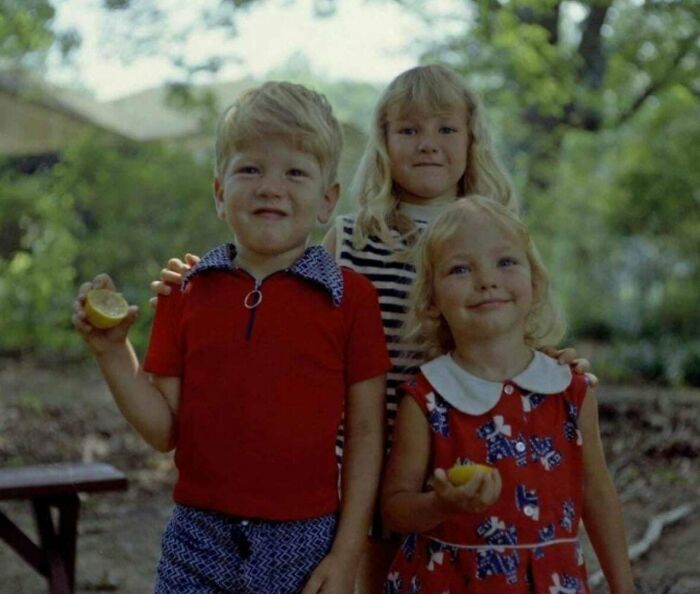 Three children smiling outdoors, holding lemons, as people share found photos capturing nostalgic moments.
