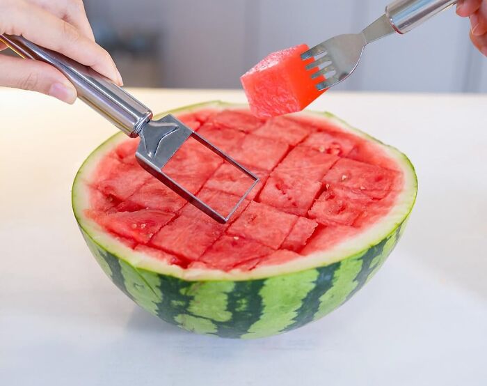 Watermelon slicer cutting cubed pieces of watermelon, one piece being lifted with a fork, popular Amazon movers and shakers product.