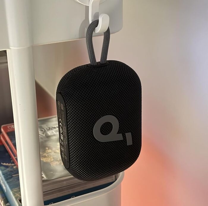 Black portable Bluetooth speaker hanging on a hook, one of the popular Amazon movers and shakers products.