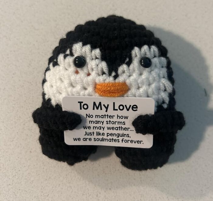 Crocheted penguin holding a love note, featured as a popular Amazon mover and shaker product.