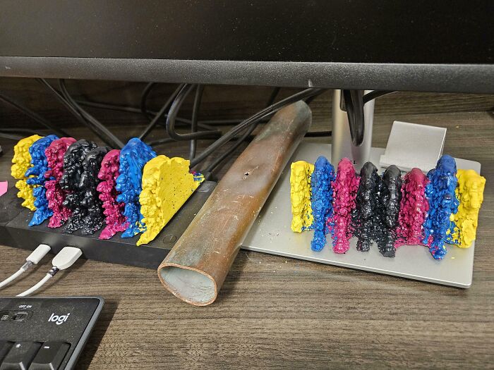 Colorful unusual textured figurine collection displayed on a desk as part of home collections with a monitor and keyboard nearby.