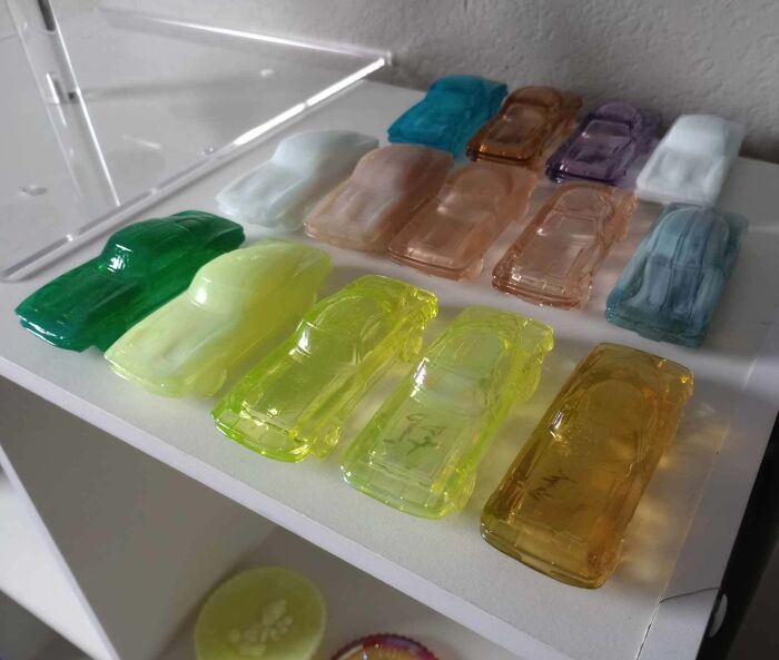 Collection of colorful translucent toy cars displayed neatly in a home showcasing unusual collections people have