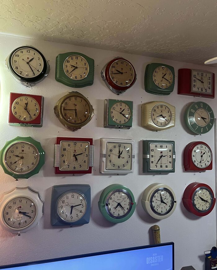 Collection of vintage wall clocks in various styles and colors displayed as an interesting and unusual home collection.