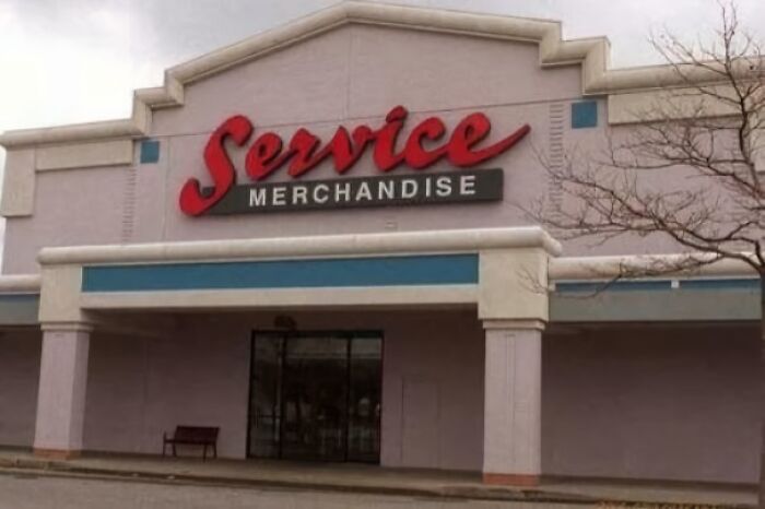 Vintage storefront with red Service Merchandise sign on a nostalgic building, evoking memories from old retail days.