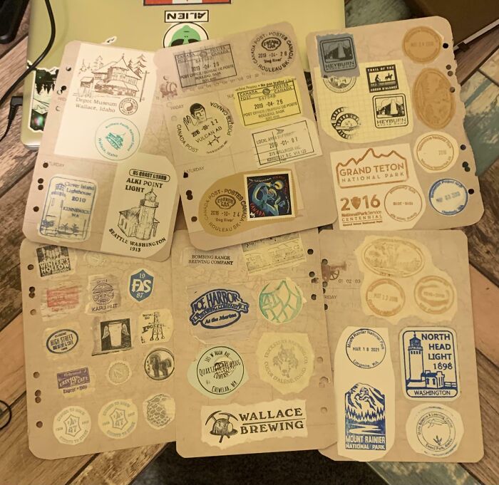 Collection of vintage travel stickers and stamps displayed on worn paper pages, showcasing unusual home collections.
