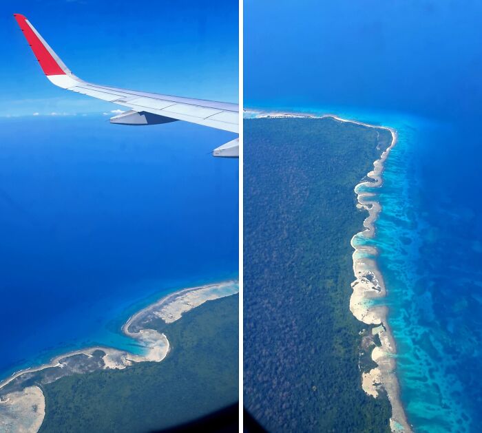 Aerial view of a coastal landscape with clear blue ocean waters seen from an airplane window, fascinating pictures for curious minds.