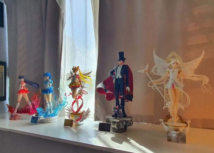 Collection of unusual anime figurines displayed on a windowsill showcasing interesting and unusual collections in homes.