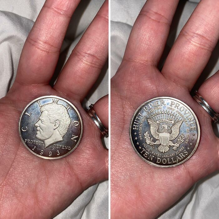 Close-up of a hand holding a 1993 Clinton ten-dollar coin, a fascinating picture for curious minds learning about the world.