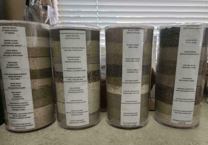 Detailed sand collection in labeled clear containers showcasing unusual home collections from beaches worldwide.