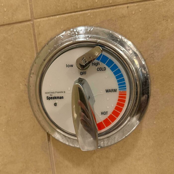 Shower thermostat with clear hot, warm, and cold labels showing a practical hotel design decision for guest comfort.