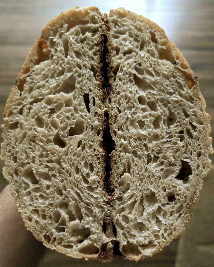 Close-up of a sliced loaf of bread with detailed texture, showing an interesting pattern that requires a double take.