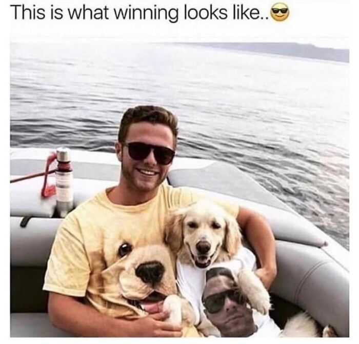 Man and golden retriever wearing matching dog memes t-shirts, sitting on a boat by the water, smiling happily.