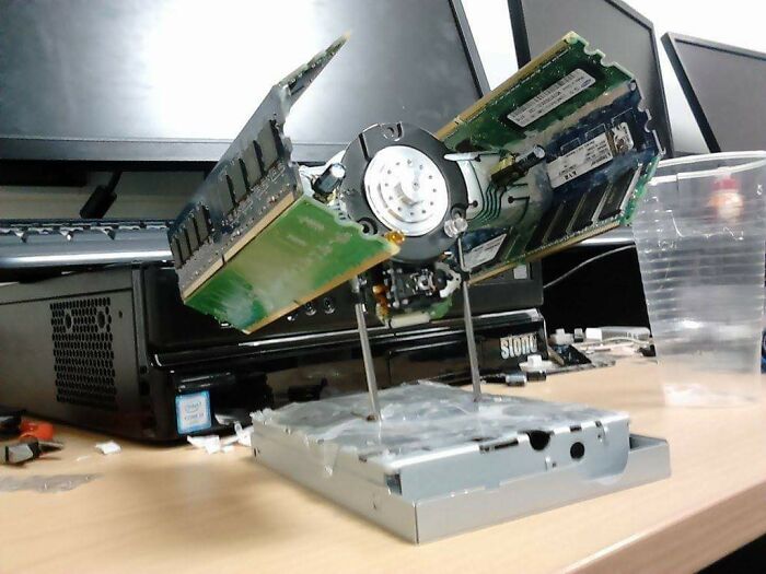 DIY project featuring repurposed computer hard drive parts assembled into a unique and creative desk sculpture.