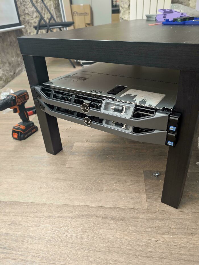 DIY project installing servers under a table, blending technology with furniture in a creative setup.