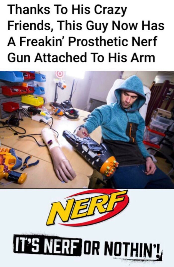 Man wearing a hoodie with a prosthetic arm modified with a Nerf gun, showcasing a creative DIY project in a workshop.
