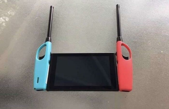 A creative DIY project combining a gaming console with two long lighters attached as controllers.